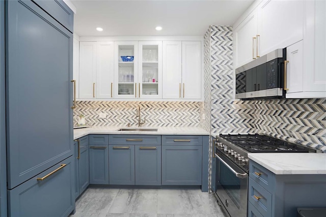 200 E 61st St Unit 19De, New York Manhattan, NY 10065 - kitchen with stainless steel appliances, a sink, backsplash, white cabinets, and recessed lighting