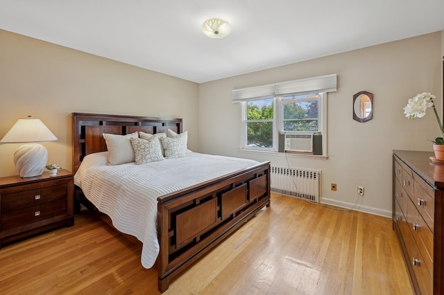151AKA149 Stone Ave, Yonkers, NY 10701 - bedroom with radiator heating unit, light wood-style floors, and cooling unit