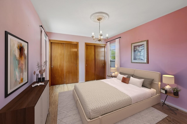 151AKA149 Stone Ave, Yonkers, NY 10701 - bedroom with wood finished floors, multiple closets, and a chandelier