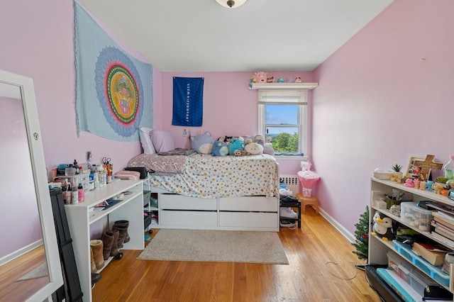 151AKA149 Stone Ave, Yonkers, NY 10701 - bedroom featuring wood finished floors and radiator heating unit