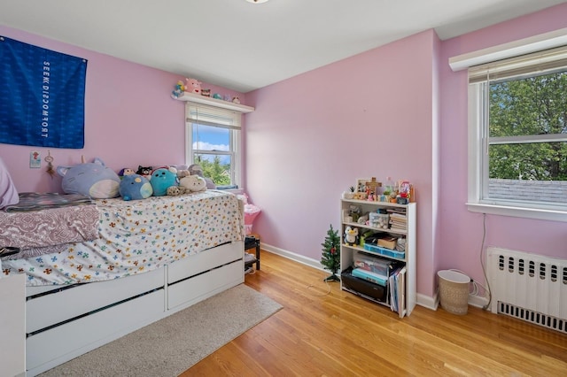 151AKA149 Stone Ave, Yonkers, NY 10701 - bedroom featuring radiator heating unit and wood finished floors