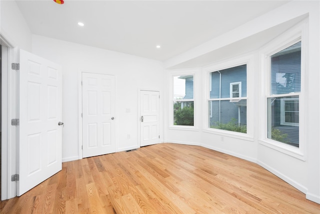 35 N St, Newburgh, NY 12550 - unfurnished bedroom with light wood-style floors, baseboards, recessed lighting, and multiple closets