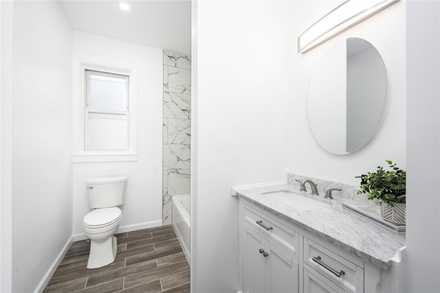35 N St, Newburgh, NY 12550 - full bathroom with vanity, toilet, wood finished floors, baseboards, and recessed lighting