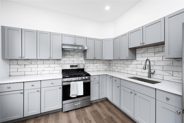 35 N St, Newburgh, NY 12550 - kitchen with gas stove, under cabinet range hood, a sink, gray cabinets, and light countertops