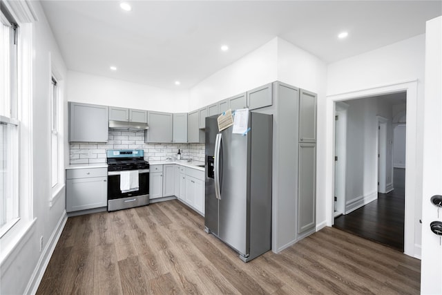 35 N St, Newburgh, NY 12550 - kitchen featuring appliances with stainless steel finishes, gray cabinets, wood finished floors, light countertops, and decorative backsplash