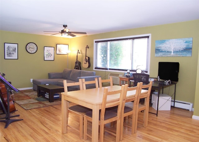 600 Fulton St Unit I-1, Farmingdale, NY 11735 - dining space featuring baseboard heating, light wood-style flooring, ceiling fan, and baseboards