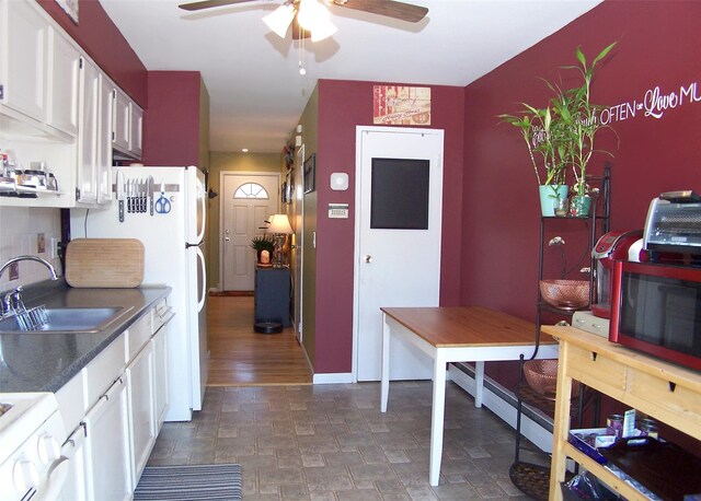 600 Fulton St Unit I-1, Farmingdale, NY 11735 - kitchen featuring a sink, ceiling fan, white cabinets, dark countertops, and stove