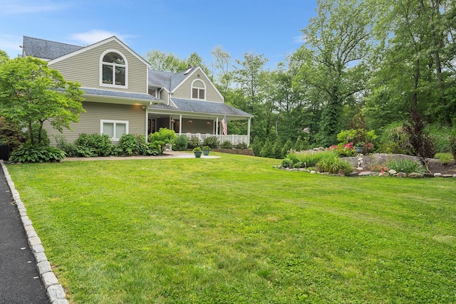 83 Mcdonald Rd, Ossining, NY 10562 - view of front of property featuring a front lawn, covered porch, and a shingled roof