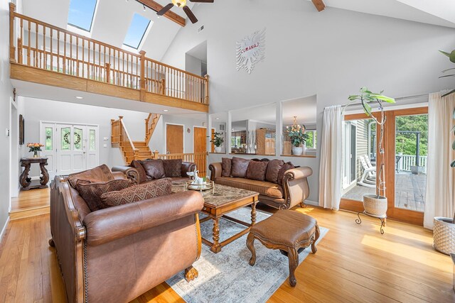 83 Mcdonald Rd, Ossining, NY 10562 - living room featuring ceiling fan, light wood-style floors, high vaulted ceiling, beamed ceiling, and stairway