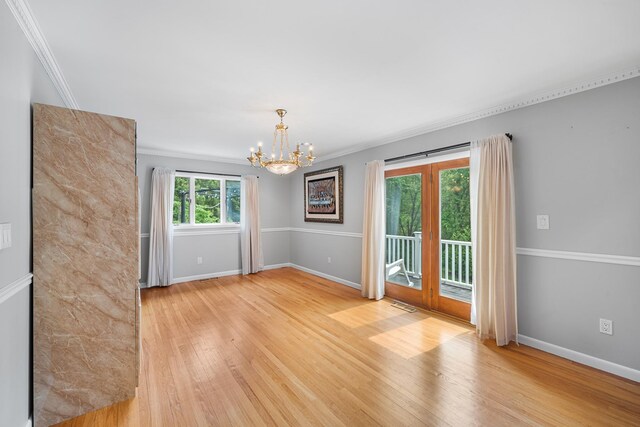 83 Mcdonald Rd, Ossining, NY 10562 - unfurnished room with light wood-type flooring, a chandelier, and crown molding