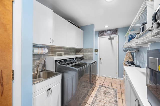 83 Mcdonald Rd, Ossining, NY 10562 - laundry area with washer and clothes dryer, cabinet space, light tile patterned floors, and recessed lighting