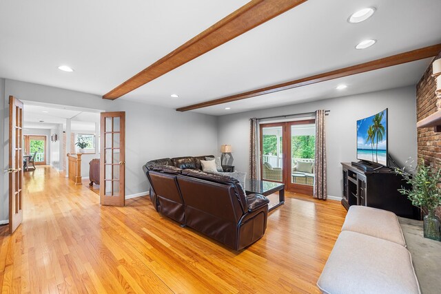 83 Mcdonald Rd, Ossining, NY 10562 - living room with french doors, light wood finished floors, healthy amount of natural light, beamed ceiling, and recessed lighting