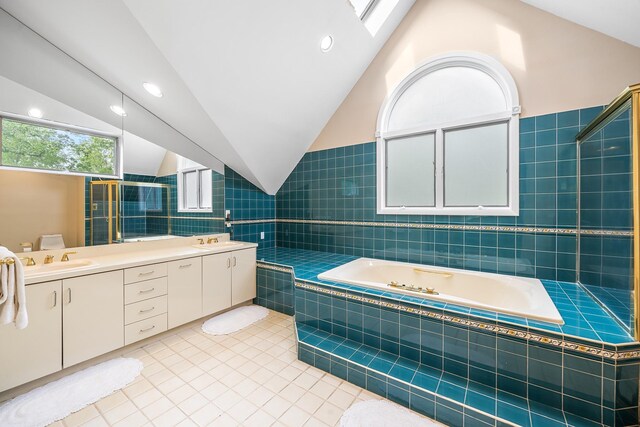 83 Mcdonald Rd, Ossining, NY 10562 - full bathroom with tiled tub, double vanity, tile walls, tile patterned flooring, and lofted ceiling
