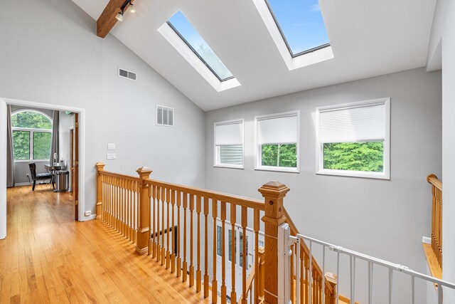 83 Mcdonald Rd, Ossining, NY 10562 - hall with a skylight, an upstairs landing, light wood-style flooring, high vaulted ceiling, and beamed ceiling