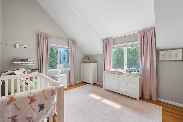 83 Mcdonald Rd, Ossining, NY 10562 - bedroom with a crib, lofted ceiling, and wood finished floors
