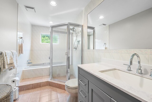 83 Mcdonald Rd, Ossining, NY 10562 - bathroom featuring vanity, a bath, tile patterned floors, a stall shower, and tile walls