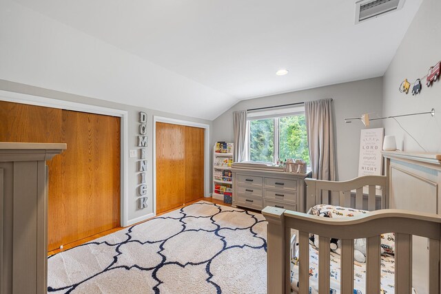 83 Mcdonald Rd, Ossining, NY 10562 - bedroom with lofted ceiling, two closets, and light wood-type flooring