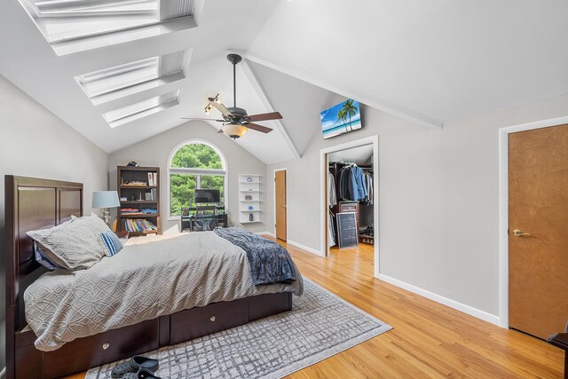 83 Mcdonald Rd, Ossining, NY 10562 - bedroom with a skylight, light wood-style flooring, vaulted ceiling, a walk in closet, and a ceiling fan