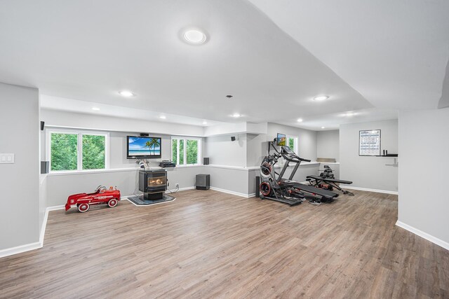 83 Mcdonald Rd, Ossining, NY 10562 - exercise area featuring a wood stove, wood finished floors, and recessed lighting