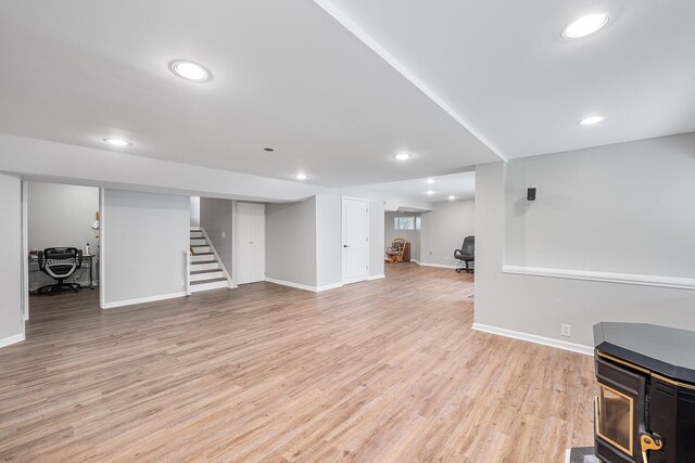 83 Mcdonald Rd, Ossining, NY 10562 - living area featuring stairway, light wood-type flooring, recessed lighting, and a wood stove