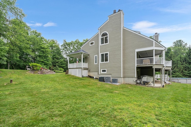 83 Mcdonald Rd, Ossining, NY 10562 - rear view of house featuring a chimney and a lawn