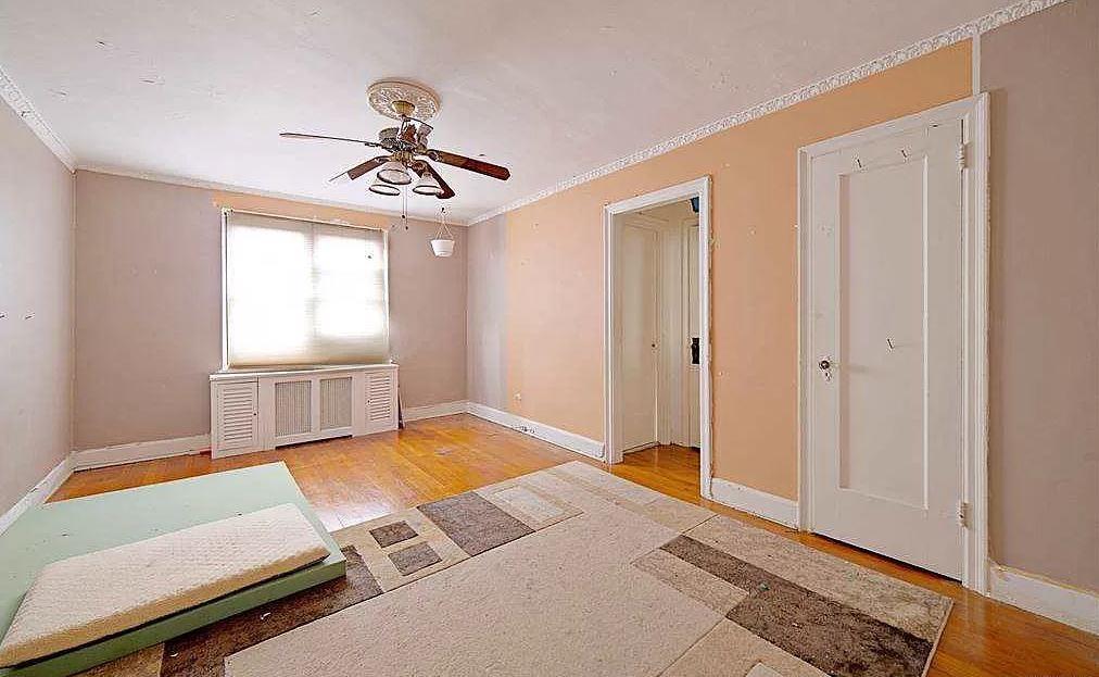 651 N Terrace Ave Unit 5B, Mount Vernon, NY 10552 - empty room with crown molding, ceiling fan, wood finished floors, baseboards, and radiator
