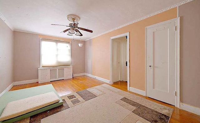 651 N Terrace Ave Unit 5B, Mount Vernon, NY 10552 - empty room with crown molding, ceiling fan, wood finished floors, baseboards, and radiator