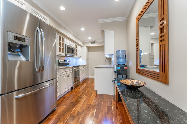 62 Alhambra Dr, Oceanside, NY 11572 - kitchen with appliances with stainless steel finishes, dark wood-style floors, ornamental molding, a sink, and white cabinetry