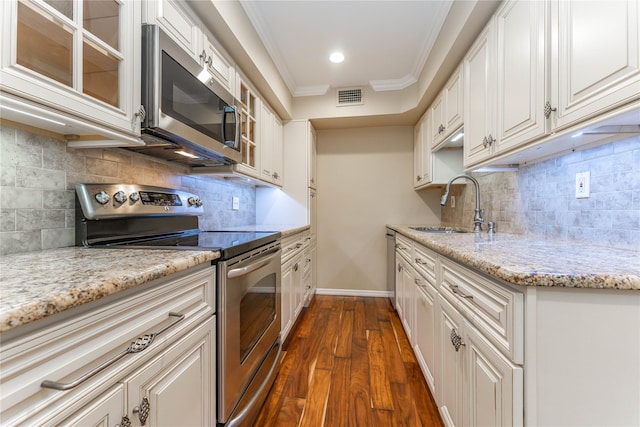 62 Alhambra Dr, Oceanside, NY 11572 - kitchen featuring appliances with stainless steel finishes, a sink, dark wood-style flooring, glass insert cabinets, and baseboards