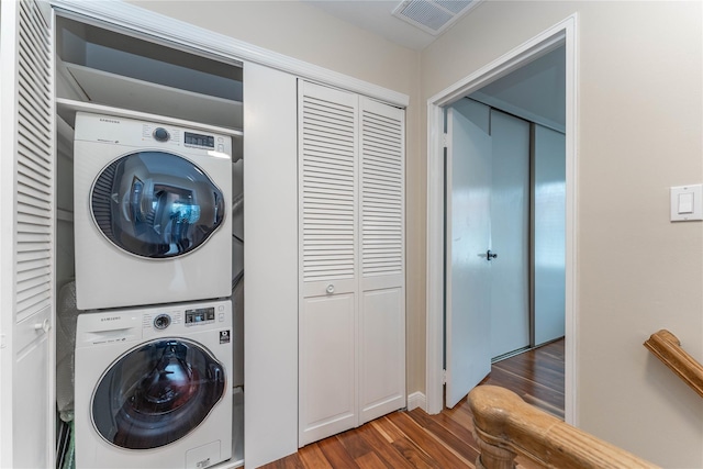 62 Alhambra Dr, Oceanside, NY 11572 - washroom featuring stacked washer / dryer and dark wood finished floors