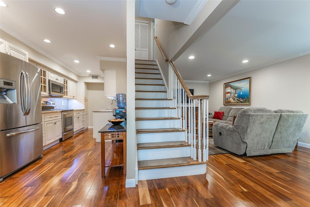 62 Alhambra Dr, Oceanside, NY 11572 - stairway with crown molding, hardwood / wood-style floors, recessed lighting, and baseboards