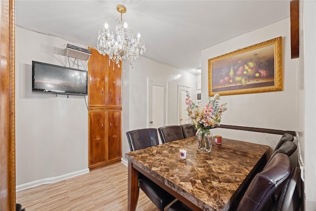 1363 Noble Ave, Bronx, NY 10472 - dining space featuring a chandelier, light wood-style flooring, and baseboards