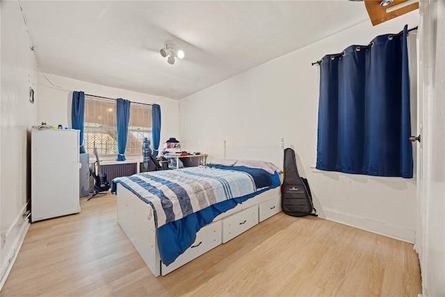 1363 Noble Ave, Bronx, NY 10472 - bedroom with wood finished floors, radiator, and baseboards