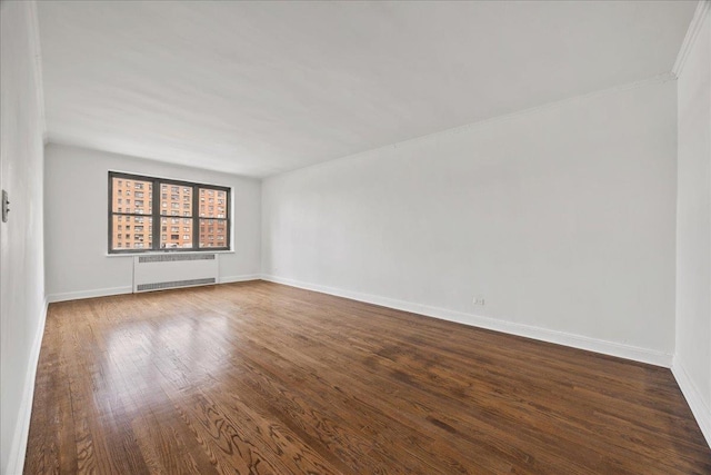 98-120 Queens Blvd Unit 5G, Rego Park, NY 11374 - unfurnished room with radiator, dark wood-style floors, and baseboards