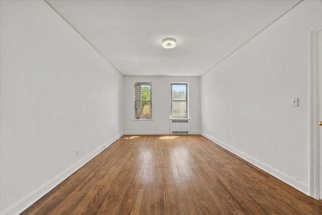 98-120 Queens Blvd Unit 5G, Rego Park, NY 11374 - unfurnished room with radiator heating unit, wood finished floors, and baseboards