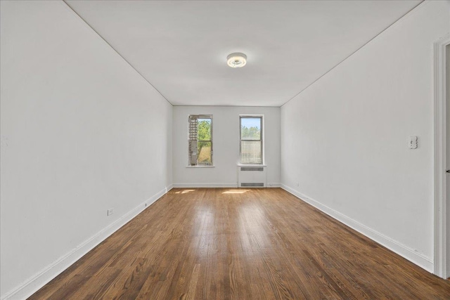 98-120 Queens Blvd Unit 5G, Rego Park, NY 11374 - unfurnished room with wood finished floors, radiator heating unit, and baseboards