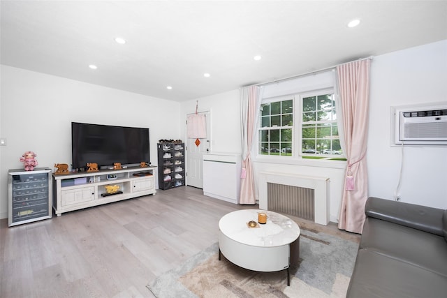 223-36 65th Ave Unit 2A, Bayside, NY 11364 - living room with radiator, beverage cooler, recessed lighting, light wood-type flooring, and an AC wall unit