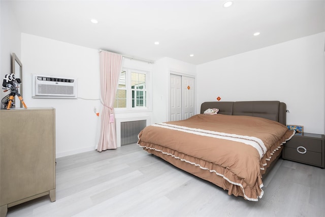 223-36 65th Ave Unit 2A, Bayside, NY 11364 - bedroom featuring radiator heating unit, light wood finished floors, a wall unit AC, recessed lighting, and a closet