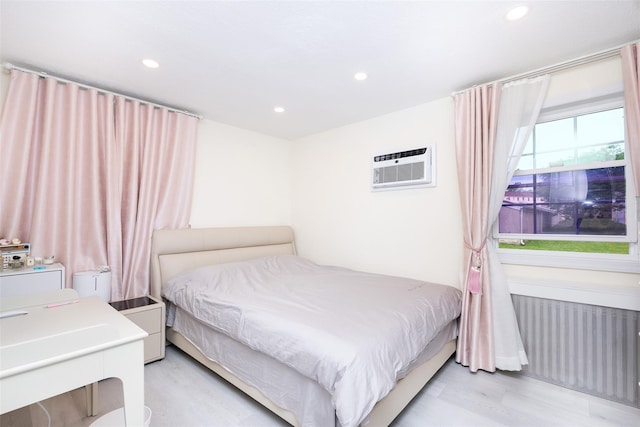 223-36 65th Ave Unit 2A, Bayside, NY 11364 - bedroom featuring radiator heating unit, light wood-style flooring, recessed lighting, and a wall mounted air conditioner