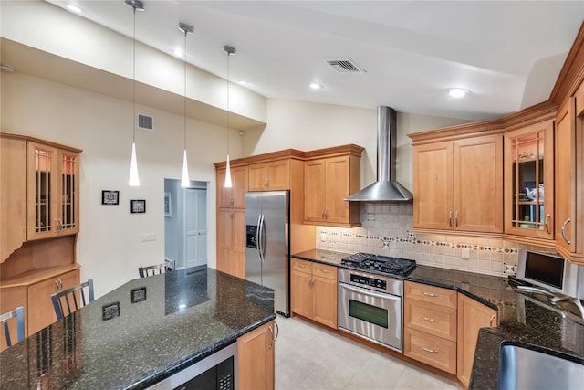 18 Commander Vic Ln, Nesconset, NY 11767 - kitchen featuring appliances with stainless steel finishes, wall chimney range hood, tasteful backsplash, glass insert cabinets, and hanging light fixtures
