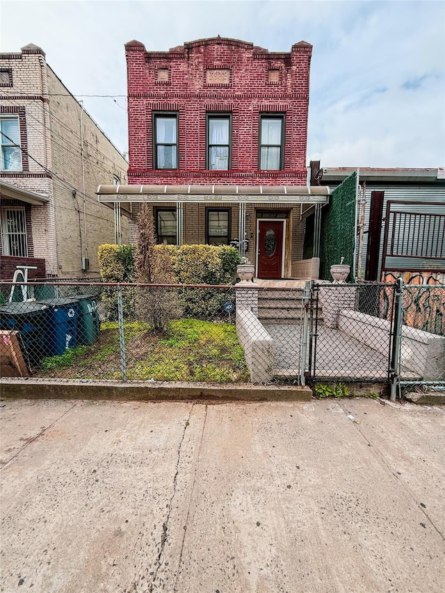 412 Newport St, Brooklyn, NY 11207 - view of front of house with brick siding, a fenced front yard, a porch, and a gate