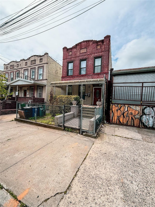 412 Newport St, Brooklyn, NY 11207 - townhome / multi-family property with a porch, a gate, and a fenced front yard