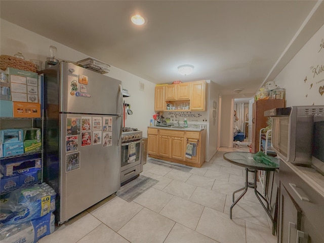 412 Newport St, Brooklyn, NY 11207 - kitchen featuring appliances with stainless steel finishes, light brown cabinetry, light countertops, and light tile patterned floors