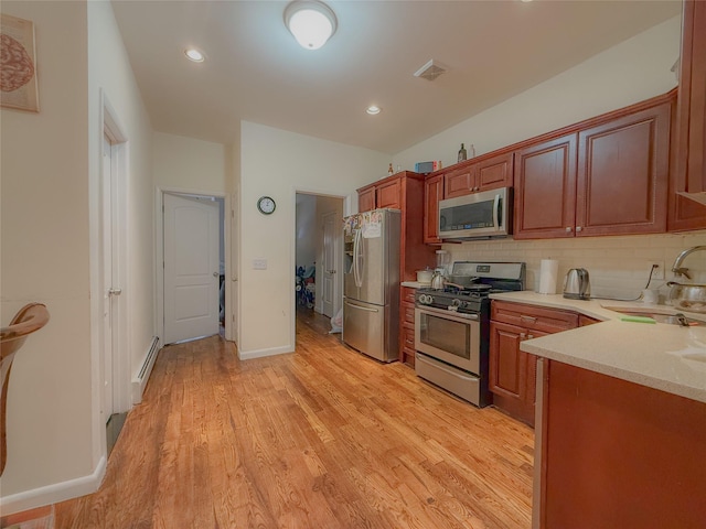 412 Newport St, Brooklyn, NY 11207 - kitchen with stainless steel appliances, a sink, light countertops, light wood-style flooring, and backsplash