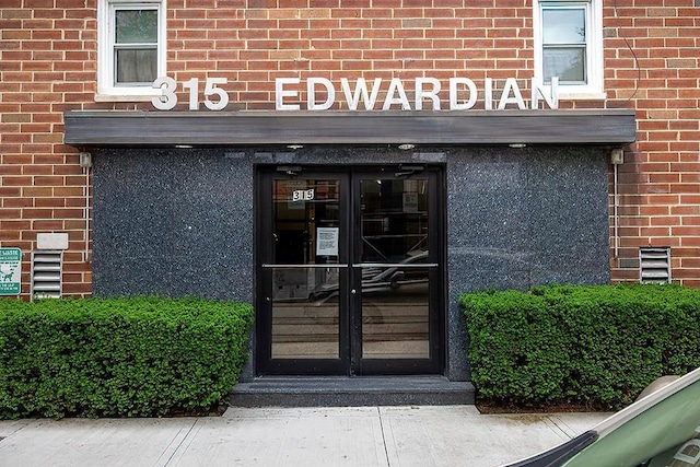 315 W 232nd St Unit 3C, Bronx, NY 10463 - view of exterior entry featuring french doors and brick siding