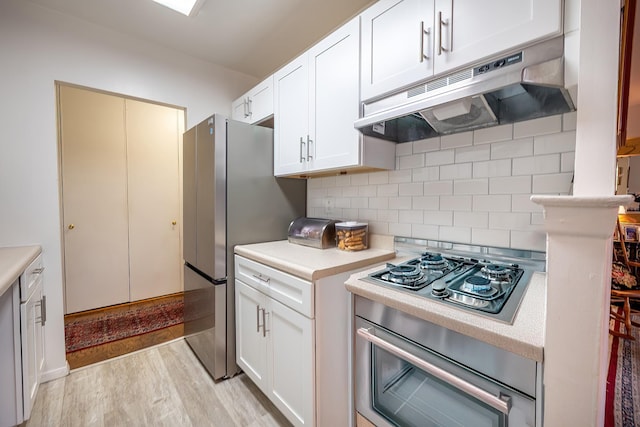 315 W 232nd St Unit 3C, Bronx, NY 10463 - kitchen with under cabinet range hood, cooktop, light countertops, backsplash, and white cabinets