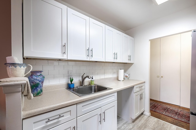 315 W 232nd St Unit 3C, Bronx, NY 10463 - kitchen featuring a sink, light countertops, tasteful backsplash, and white cabinetry