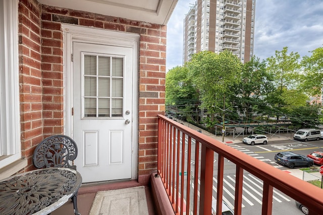 315 W 232nd St Unit 3C, Bronx, NY 10463 - entrance to property featuring brick siding, uncovered parking, and a balcony