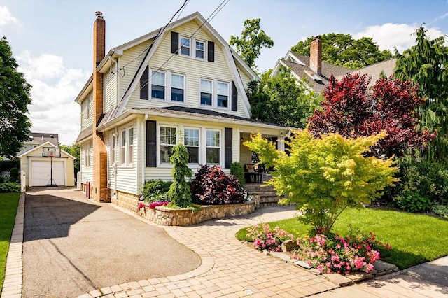 344 N Forest Ave, Rockville Centre, NY 11570 - dutch colonial featuring driveway, an outbuilding, a gambrel roof, a chimney, and a garage