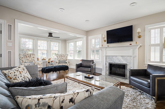 344 N Forest Ave, Rockville Centre, NY 11570 - living room with wood finished floors, a high end fireplace, baseboards, and a ceiling fan